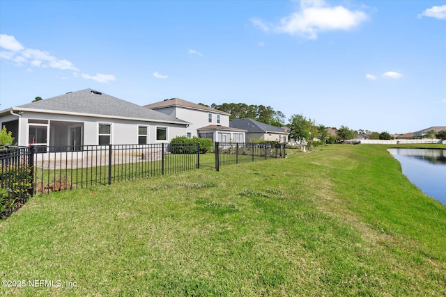 view of yard featuring a water view and fence
