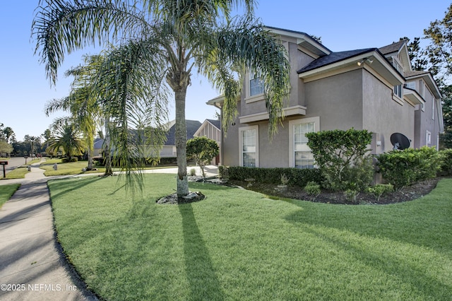 view of property exterior featuring a yard and stucco siding