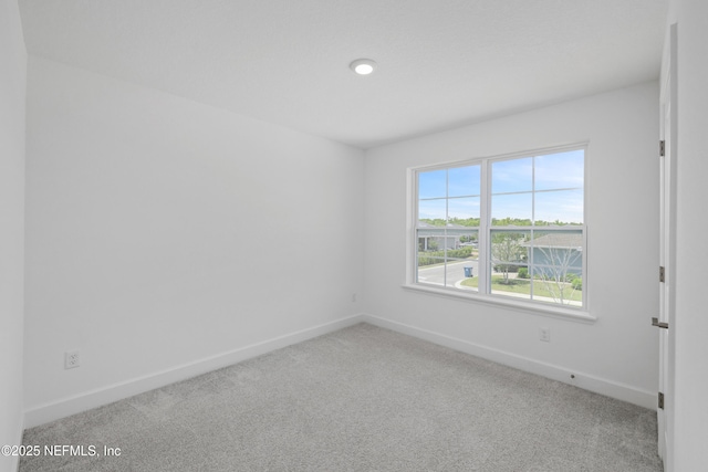 spare room with carpet flooring and baseboards
