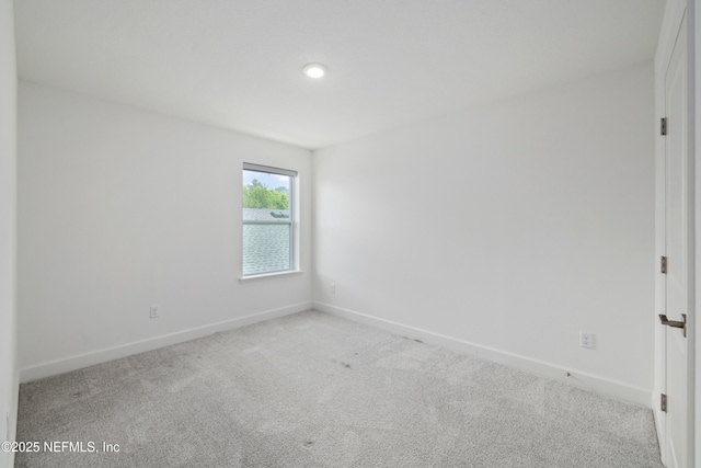 carpeted empty room with baseboards and recessed lighting