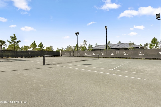 view of tennis court with fence