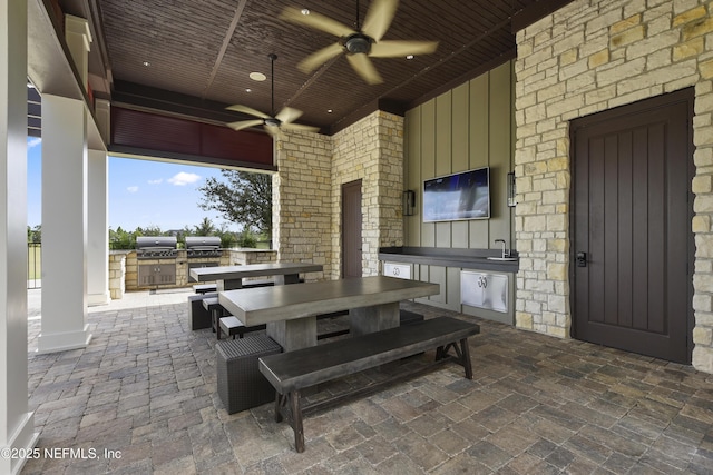 view of patio / terrace with a grill, a ceiling fan, outdoor dining space, a sink, and area for grilling