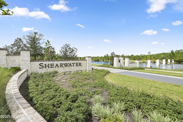 community sign with a water view