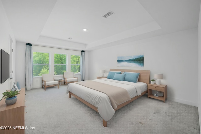 bedroom with a tray ceiling, visible vents, and light colored carpet