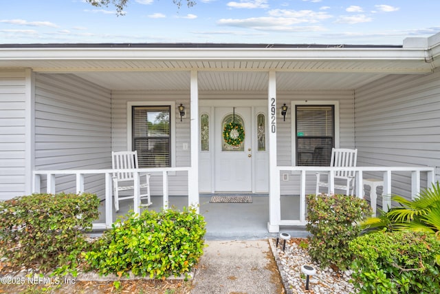 doorway to property featuring covered porch
