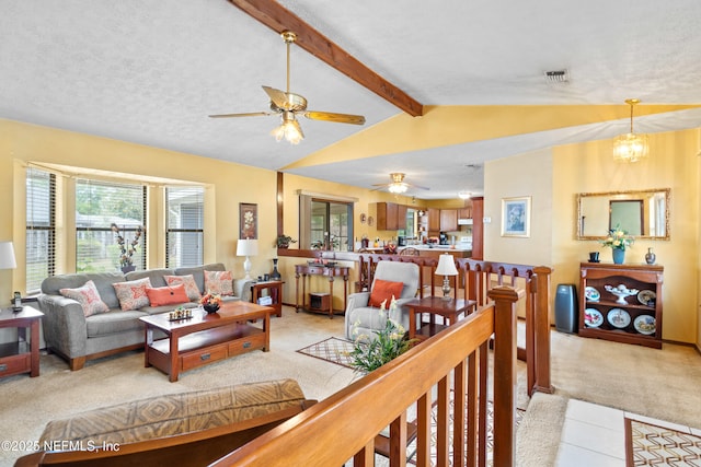 living room with vaulted ceiling with beams, a ceiling fan, visible vents, and light colored carpet