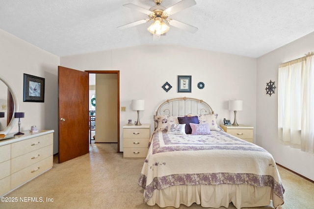 bedroom featuring a ceiling fan, light colored carpet, and lofted ceiling