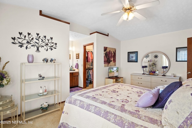 bedroom with ceiling fan, a walk in closet, carpet, lofted ceiling, and a closet