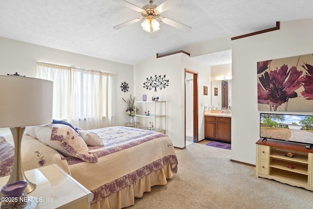 bedroom featuring baseboards, light colored carpet, a textured ceiling, and lofted ceiling