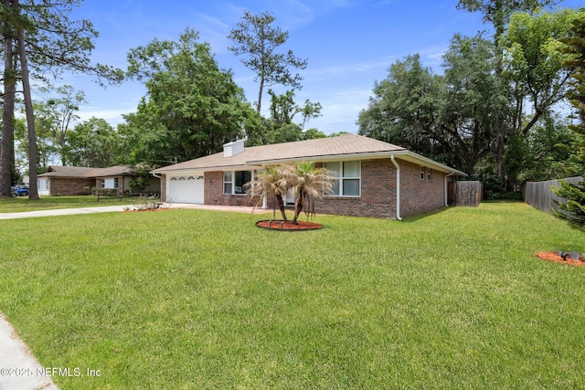 ranch-style home featuring an attached garage, fence, driveway, and a front yard