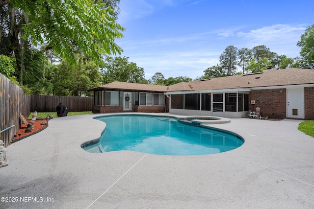 view of pool with a fenced backyard, a patio, a sunroom, and a pool with connected hot tub