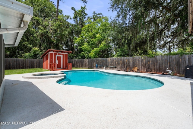 view of swimming pool featuring a patio, a fenced backyard, a storage unit, and a fenced in pool