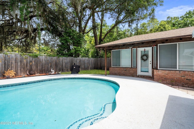 view of swimming pool featuring a fenced in pool, a fenced backyard, and a patio