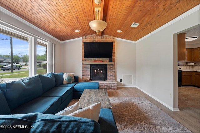 living area featuring ornamental molding, wood ceiling, and wood finished floors
