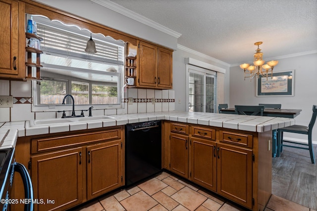 kitchen with brown cabinets, a sink, a chandelier, black dishwasher, and a peninsula