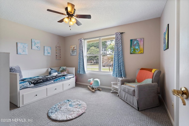 carpeted bedroom with baseboards, a textured ceiling, and ceiling fan