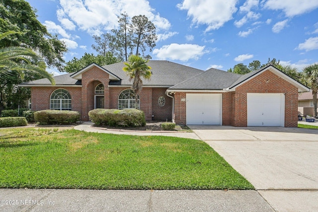 single story home with an attached garage, a front lawn, brick siding, and concrete driveway