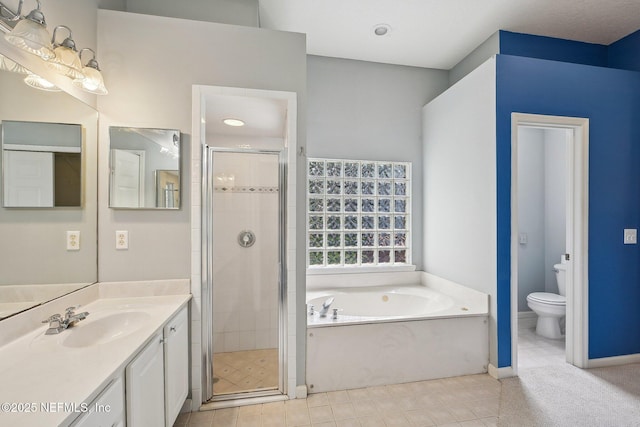 full bath with vanity, a garden tub, toilet, tile patterned floors, and a stall shower