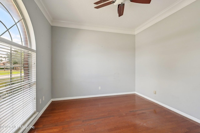 empty room with crown molding, a ceiling fan, baseboards, and wood finished floors