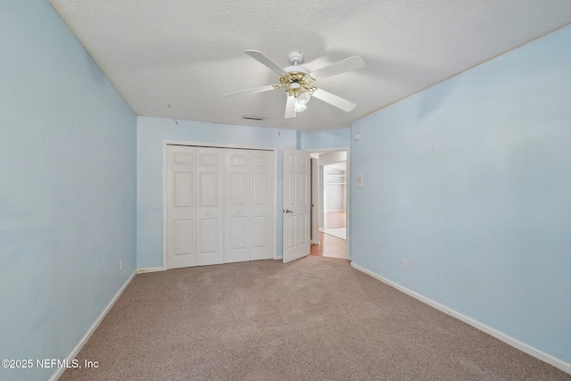unfurnished bedroom featuring carpet floors, baseboards, visible vents, and a closet