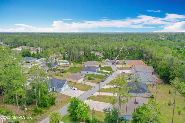 drone / aerial view with a residential view and a wooded view