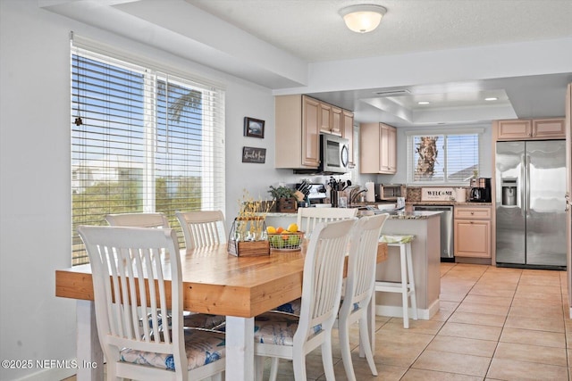 3365 N Ocean Shore Blvd, Flagler Beach, FL 32136 - dining room with a raised ceiling and light tile patterned floors