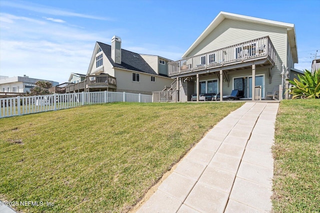 3365 N Ocean Shore Blvd, Flagler Beach, FL 32136 - back of house with a fenced backyard, a yard, a chimney, and a deck