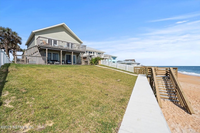 3365 N Ocean Shore Blvd, Flagler Beach, FL 32136 - rear view of house with a lawn, fence, and a water view