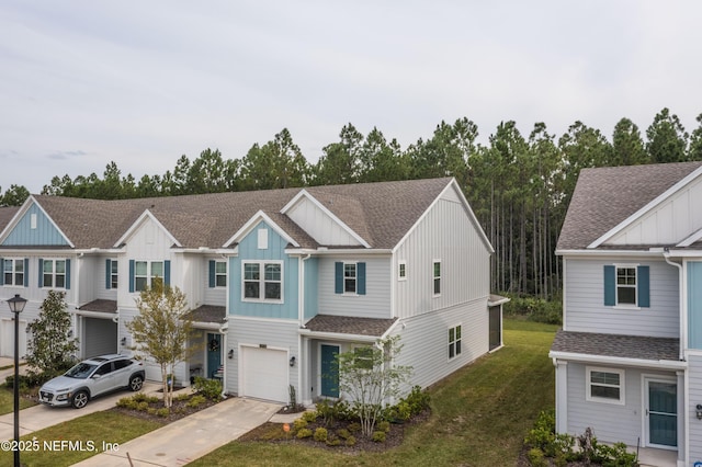 10318 Benson Lake Dr, Jacksonville, FL 32222 - multi unit property with board and batten siding, concrete driveway, an attached garage, a front lawn, and roof with shingles
