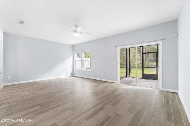 10318 Benson Lake Dr, Jacksonville, FL 32222 - empty room featuring a ceiling fan, wood finished floors, and baseboards