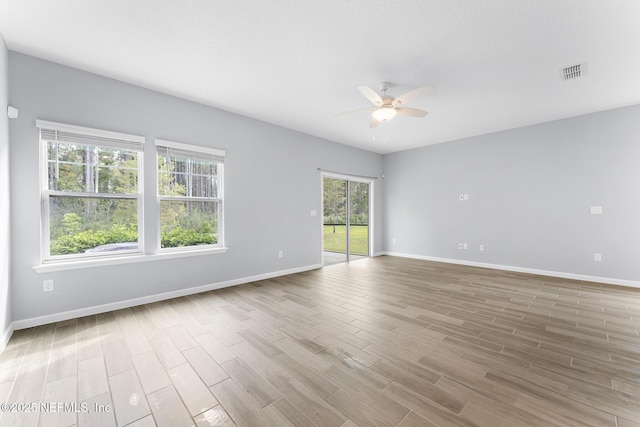 10318 Benson Lake Dr, Jacksonville, FL 32222 - spare room with ceiling fan, wood finished floors, and baseboards