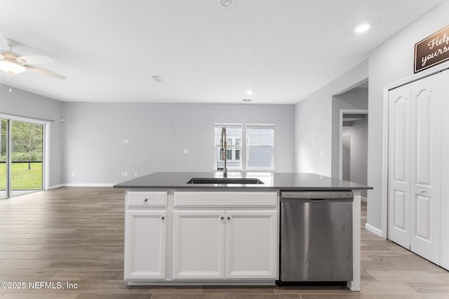 10318 Benson Lake Dr, Jacksonville, FL 32222 - kitchen with stainless steel dishwasher, open floor plan, a sink, ceiling fan, and wood finished floors