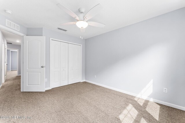 10318 Benson Lake Dr, Jacksonville, FL 32222 - unfurnished bedroom with carpet, a closet, baseboards, and a ceiling fan