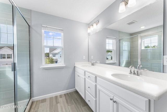10318 Benson Lake Dr, Jacksonville, FL 32222 - bathroom with healthy amount of natural light, a stall shower, baseboards, and wood finished floors