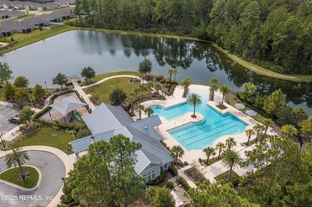 10318 Benson Lake Dr, Jacksonville, FL 32222 - drone / aerial view of a pool, a nearby body of water, and a heavily wooded area