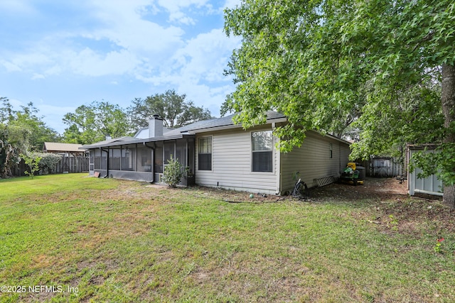 400 Harvest Bend Dr, Fleming Island, FL 32003 - rear view of house with a sunroom, a chimney, and a storage shed