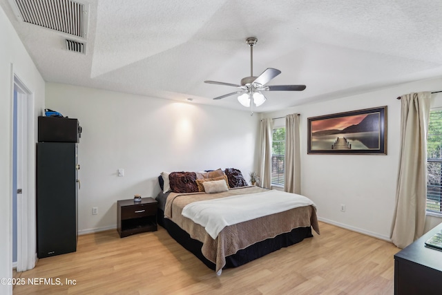 400 Harvest Bend Dr, Fleming Island, FL 32003 - bedroom with light wood-style floors, baseboards, ceiling fan, and a textured ceiling