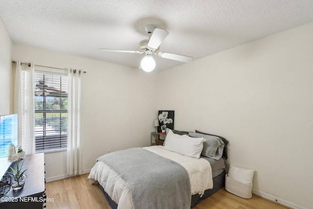 400 Harvest Bend Dr, Fleming Island, FL 32003 - bedroom featuring light wood-type flooring, baseboards, ceiling fan, and a textured ceiling
