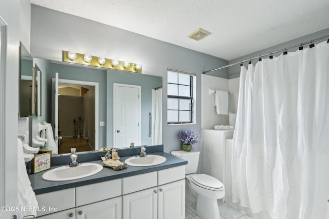 400 Harvest Bend Dr, Fleming Island, FL 32003 - full bathroom featuring double vanity, toilet, a textured ceiling, tile patterned flooring, and a shower with shower curtain