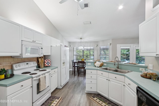 400 Harvest Bend Dr, Fleming Island, FL 32003 - kitchen featuring white appliances, a sink, tasteful backsplash, white cabinets, and lofted ceiling