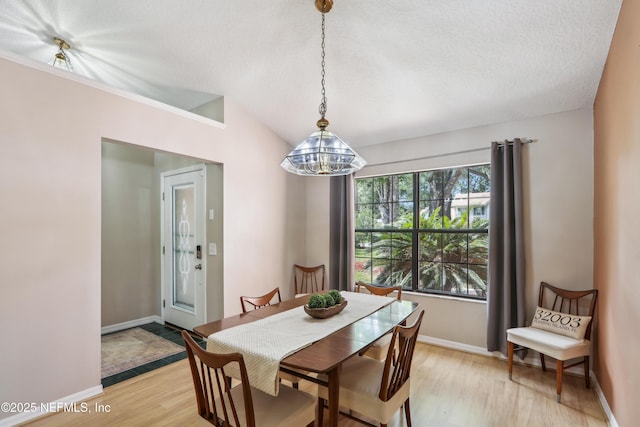 400 Harvest Bend Dr, Fleming Island, FL 32003 - dining room with light wood-style floors, baseboards, a chandelier, and a textured ceiling