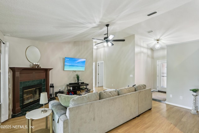 400 Harvest Bend Dr, Fleming Island, FL 32003 - living room with wood finished floors, a fireplace, a ceiling fan, baseboards, and vaulted ceiling