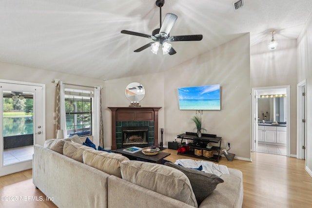400 Harvest Bend Dr, Fleming Island, FL 32003 - living area featuring vaulted ceiling, wood finished floors, a ceiling fan, a tile fireplace, and baseboards