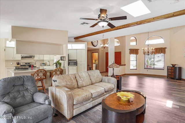 5088 Merrifield Ct, Spring Hill, FL 34608 - living area with visible vents, beamed ceiling, baseboards, dark wood-type flooring, and ceiling fan with notable chandelier