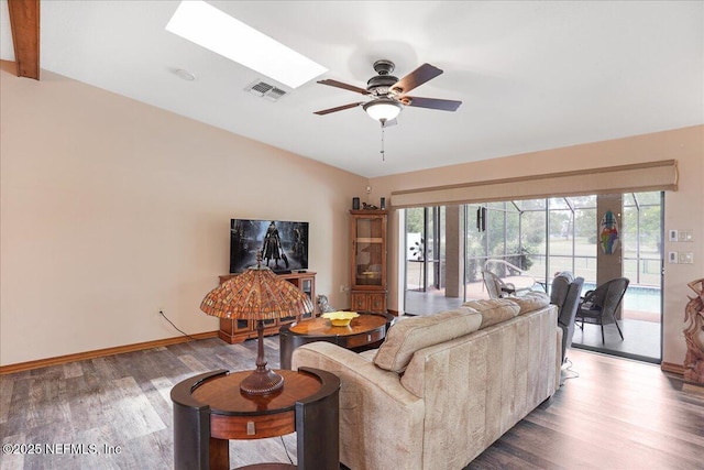 5088 Merrifield Ct, Spring Hill, FL 34608 - living room featuring a ceiling fan, baseboards, wood finished floors, a skylight, and visible vents