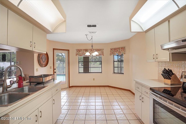 5088 Merrifield Ct, Spring Hill, FL 34608 - kitchen featuring stainless steel range with electric cooktop, a sink, tasteful backsplash, under cabinet range hood, and visible vents