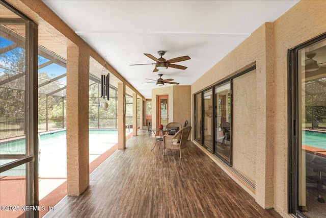 5088 Merrifield Ct, Spring Hill, FL 34608 - unfurnished sunroom featuring plenty of natural light, a textured wall, and wood finished floors