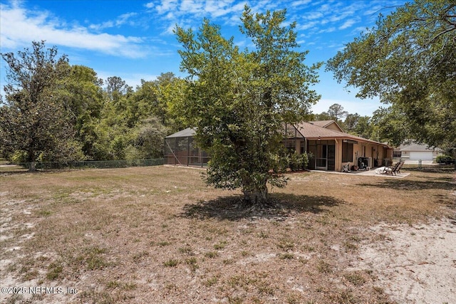 5088 Merrifield Ct, Spring Hill, FL 34608 - view of yard with fence, a lanai, and a sunroom