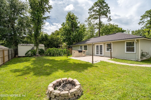 2599 Sandy Hollow Dr, Middleburg, FL 32068 - fenced yard with french doors, a patio area, an outdoor fire pit, and a shed