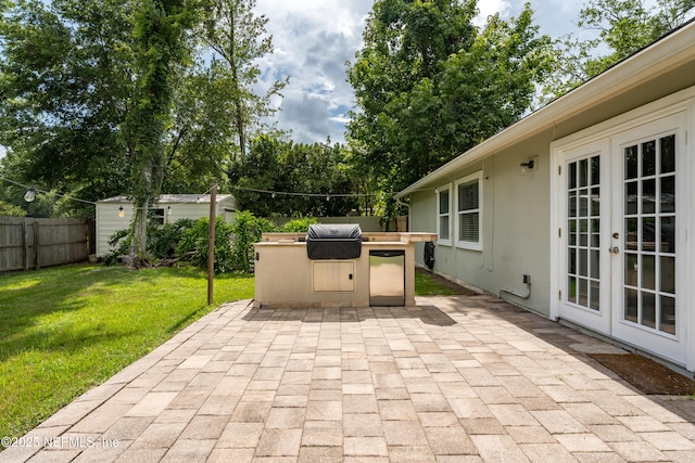 2599 Sandy Hollow Dr, Middleburg, FL 32068 - fenced backyard with a patio area, area for grilling, and french doors